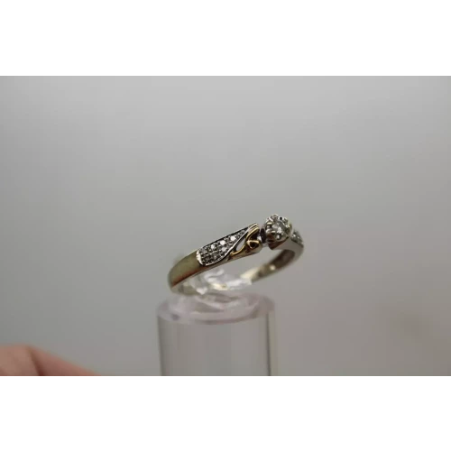 10k W.G. .11ctw DIAMOND SOLITAIRE w/ accents Ring size 9.75