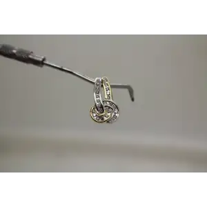 Signed 14k Y.G. & W.G. .24ctw DIAMOND KNOT DESIGN pendant