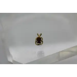 14k Y.G. Oval Cut GARNET KNOT DESIGN pendant #