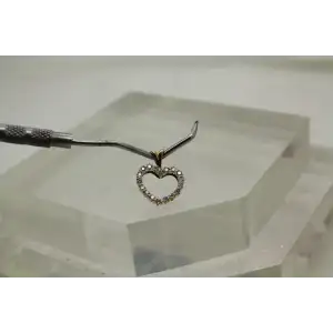 Signed 10k Y.G. .18ctw DIAMOND OPEN HEART DESIGN pendant
